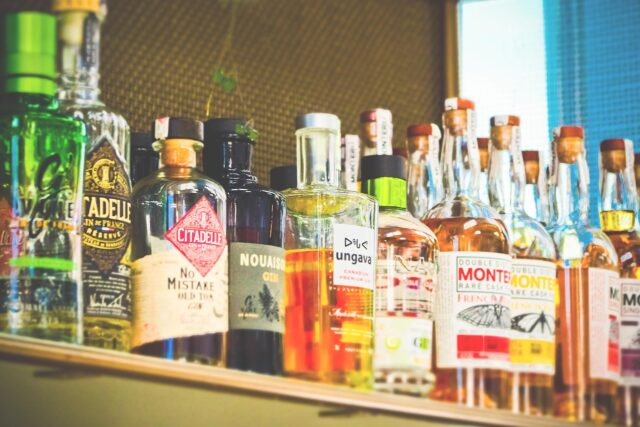 A shelf of various bottles of alcohol at a bar; Florida's Social Host Liability Laws concept image
