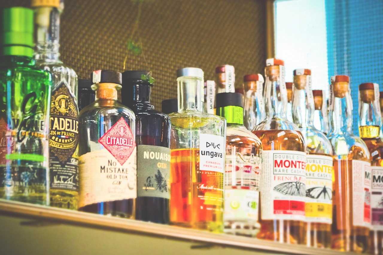 A shelf of various bottles of alcohol at a bar; Florida's Social Host Liability Laws concept image