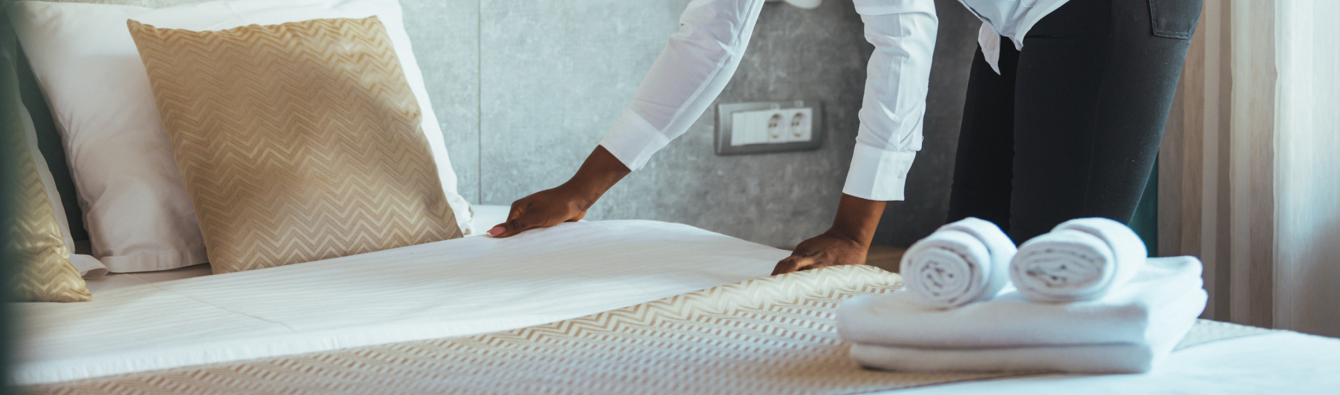 Maid making bed in hotel room Housekeeper Making Bed Maid making bed in hotel room