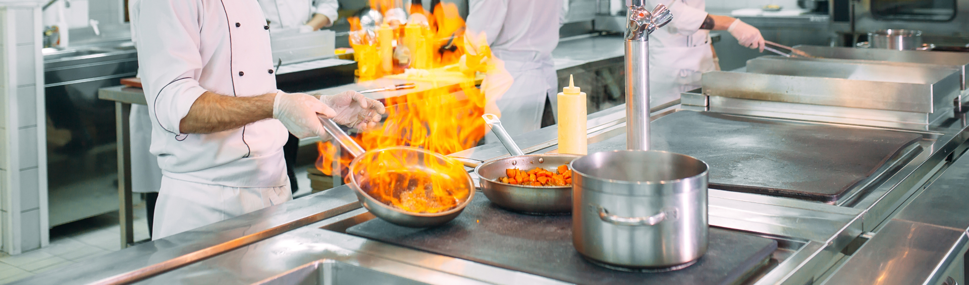 Modern kitchen Cooks prepare meals on the stove in the kitchen of the restaurant or hotel