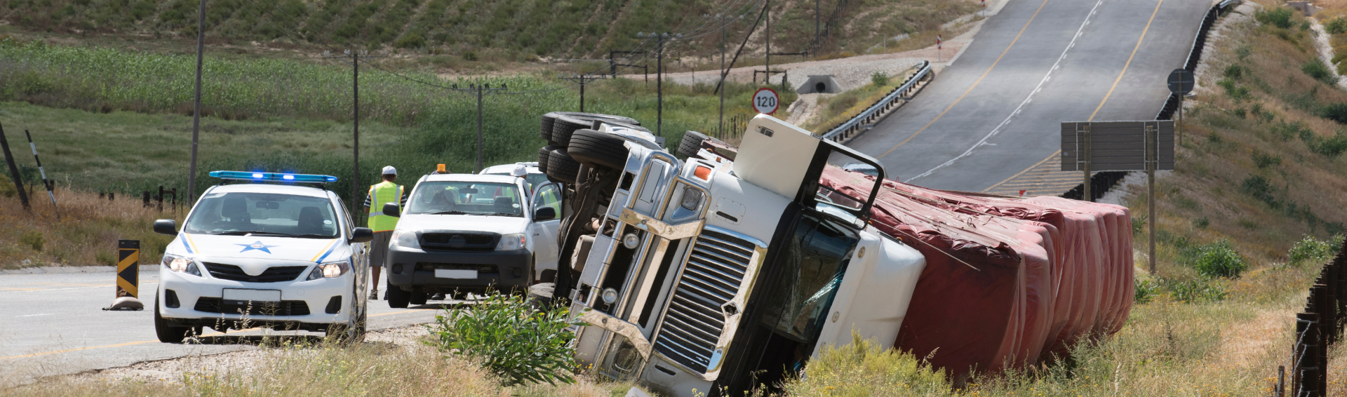 A truck flipped over on the side of the road - Panama City Truck Accident Attorneys concept image