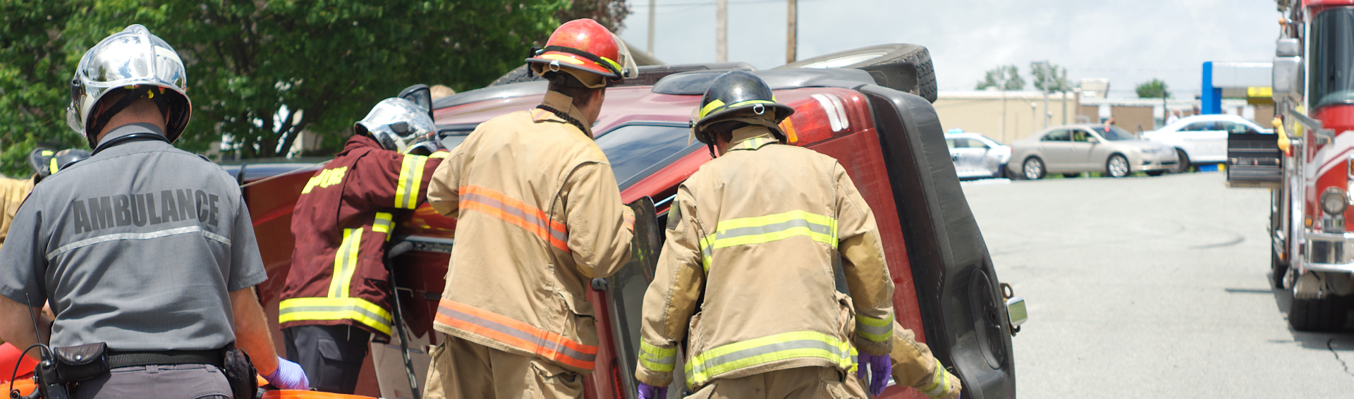 Emergency workers try to save a passenger from and overturned vehicle on a Florida road - Panama City Car Accident Attorneys